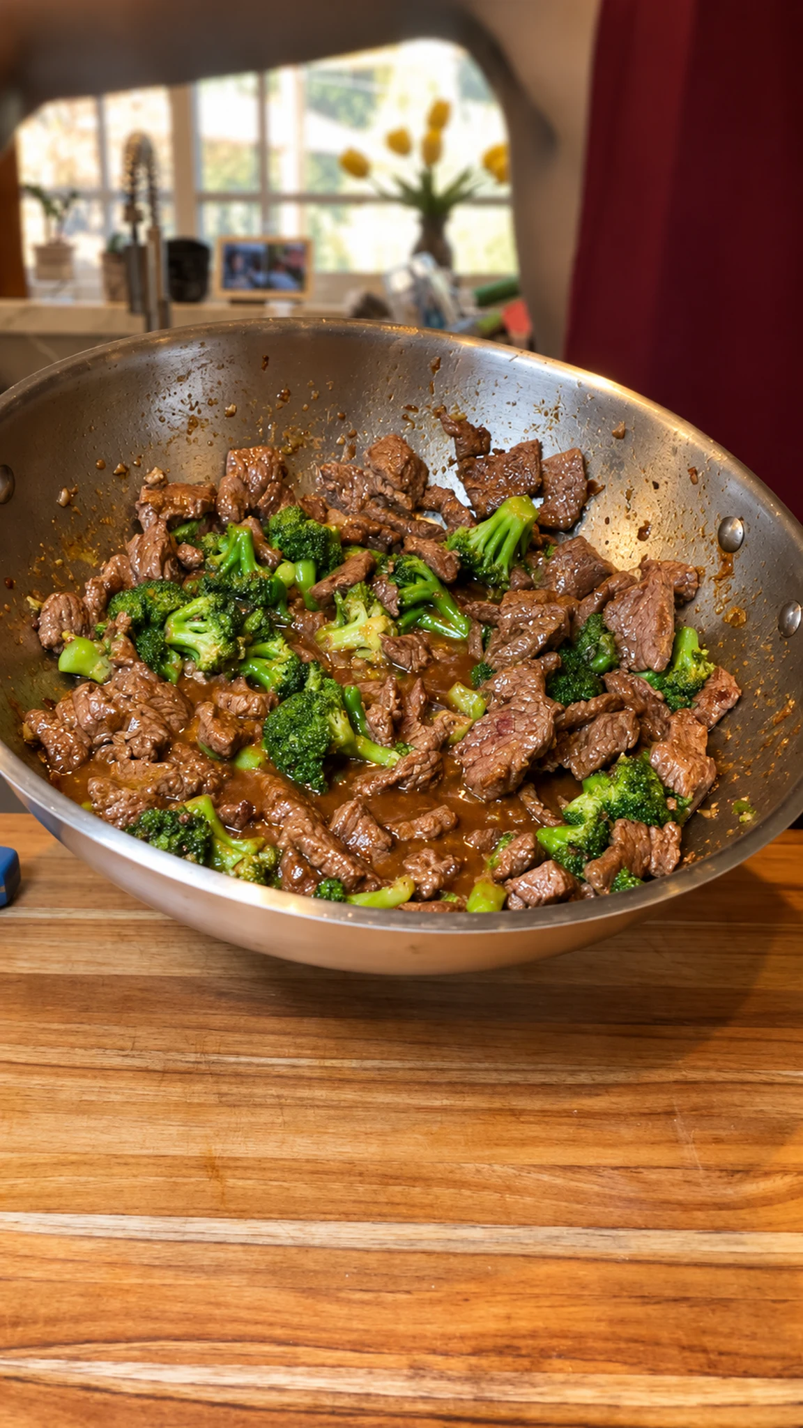 Filmed adult wok with beef and broccoli in sauce