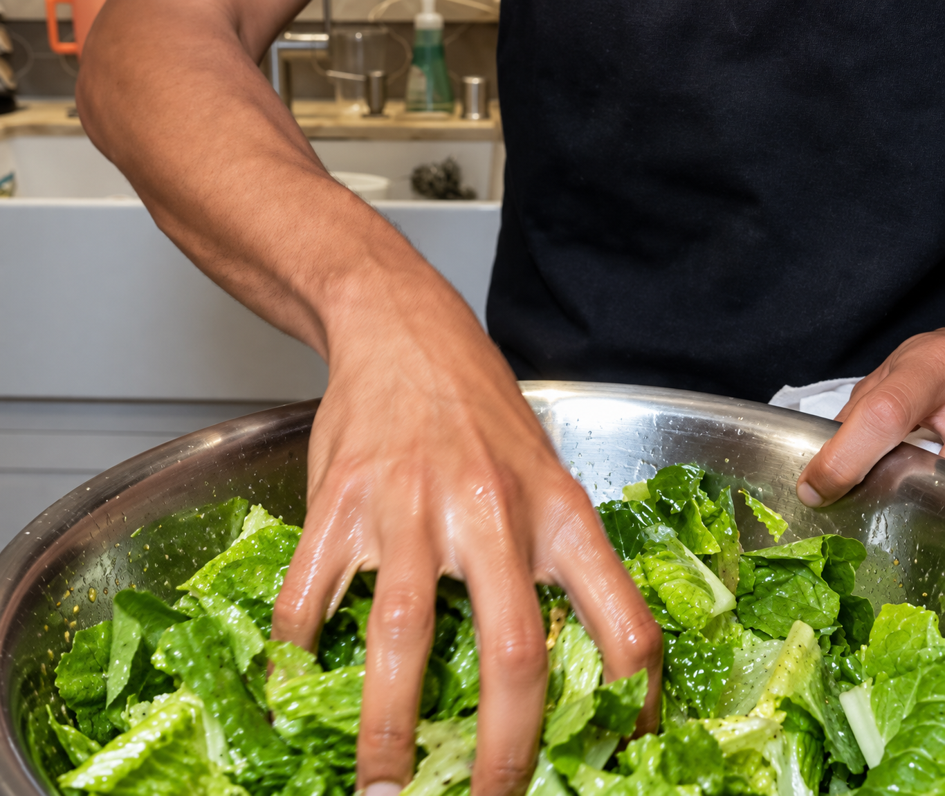 Romaine being tossed in the filmed salad bowl